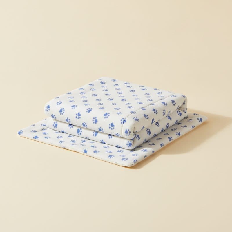 Two washable reusable dog pee pads with paw print pattern